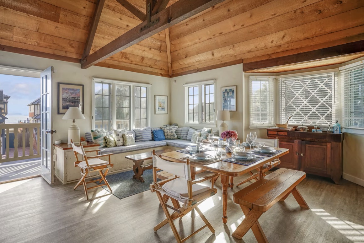 The family room upstairs, French doors open to the balcony and the Pacific beyond