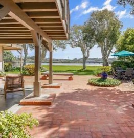 The covered brick loggia looking across the lawn to the lagoon