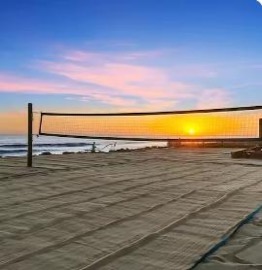 Sand volleyball net on the beach at sunset